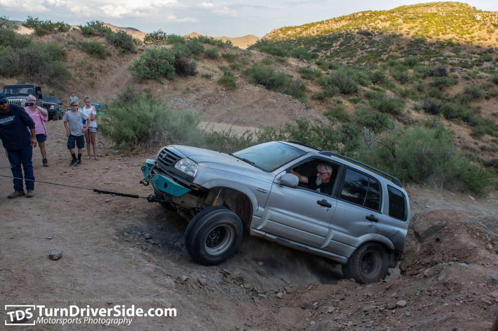 A Suzuki Grand Vitara searching for traction on the back road to Crown King, AZ