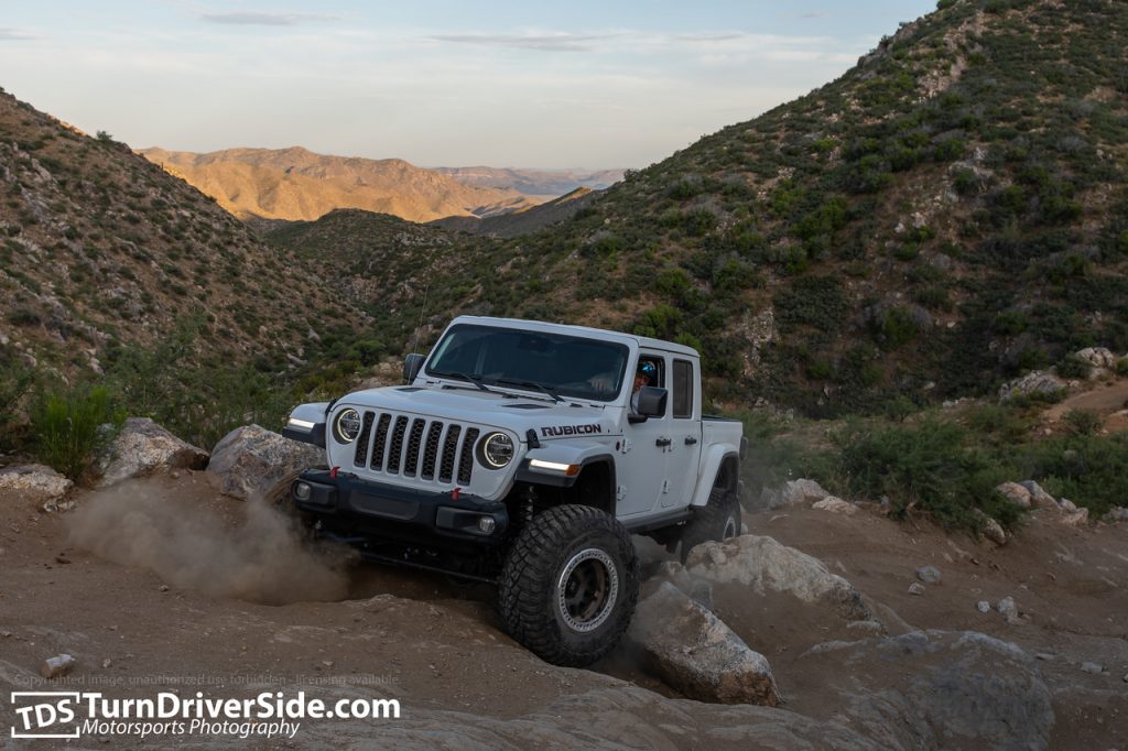 Jagged X Jeep Gladiator searching for traction on the stairs steps obstacle on the back road to Crown King, AZ